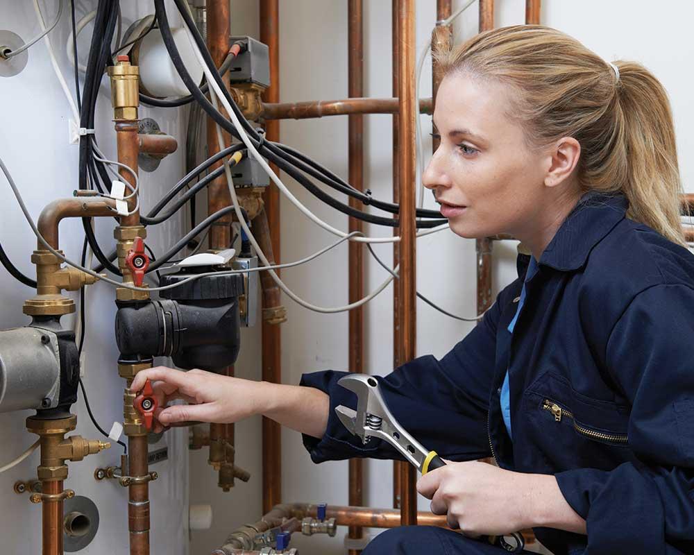 Gas engineer checking pipes