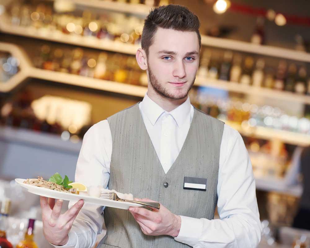 Waiter carrying a plate of food