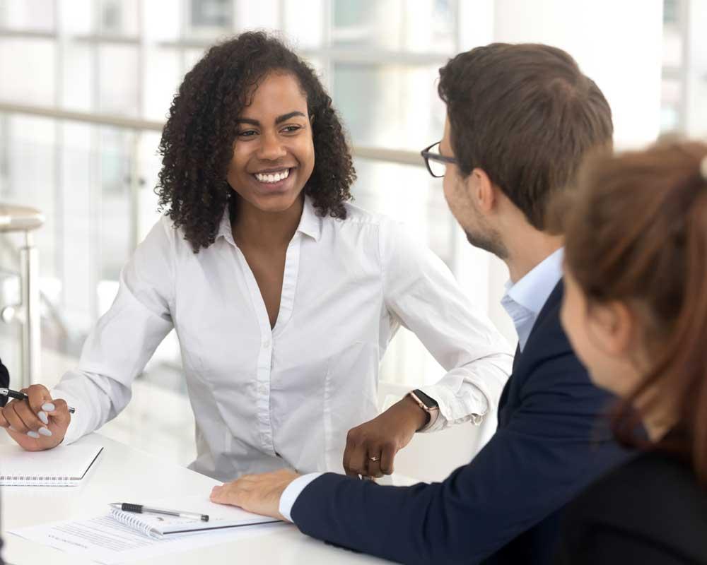 Three office workers in a meeting