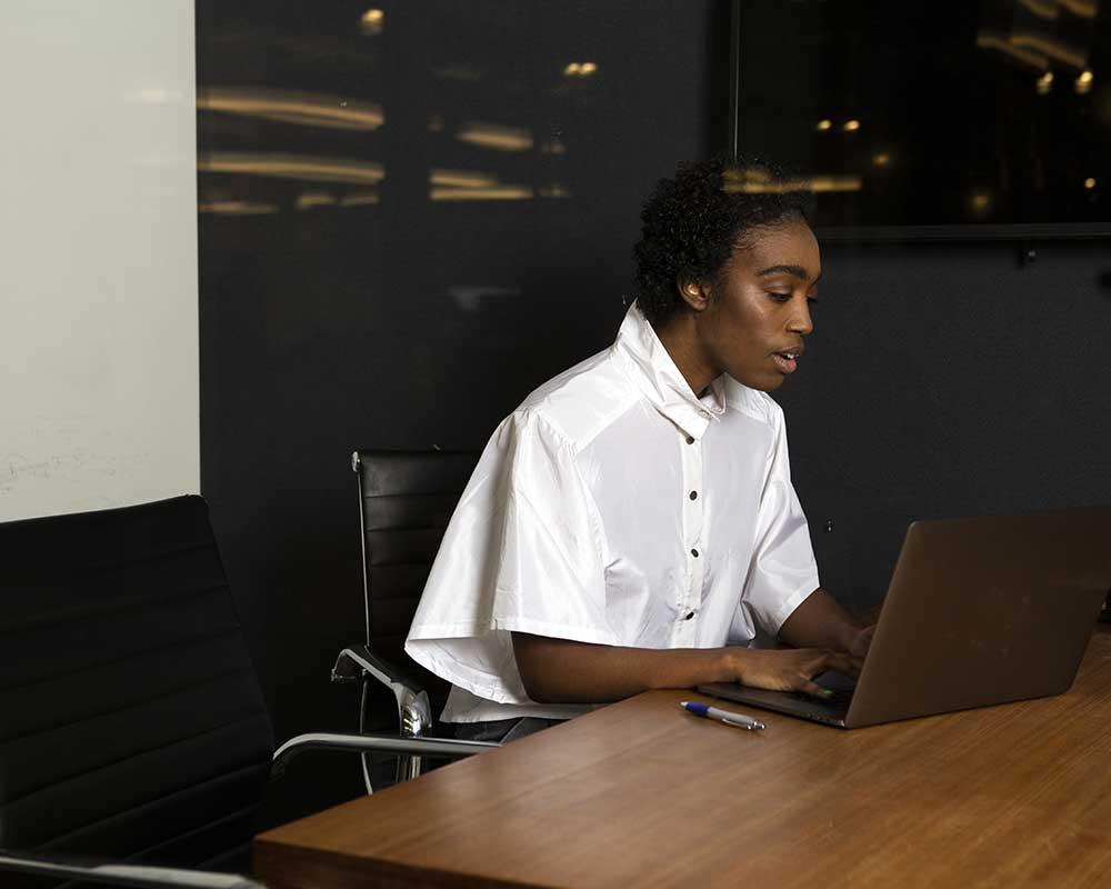 Solicitor apprentice working at laptop