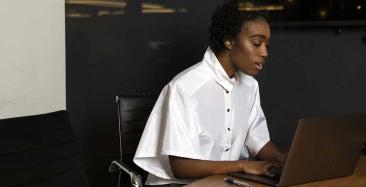 Solicitor apprentice working at laptop