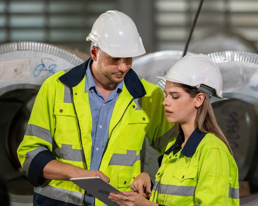 Engineering apprentice talking to colleague