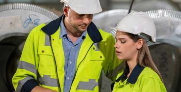 Engineering apprentice talking to colleague
