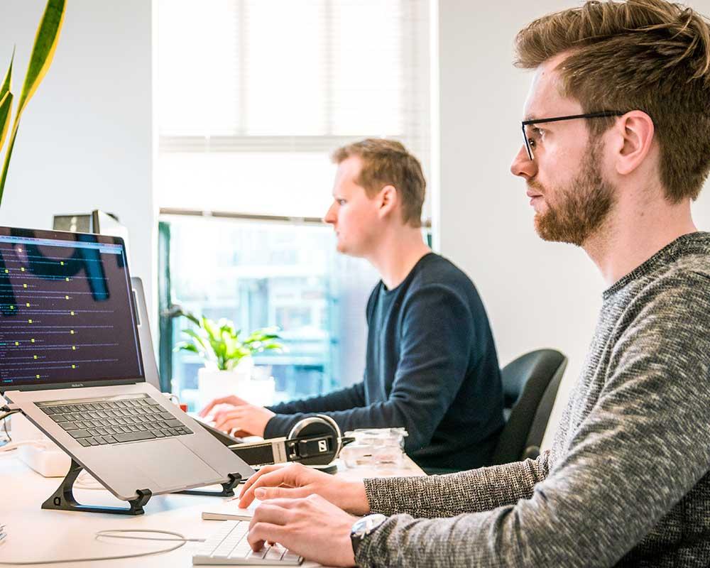 Admin assistant sitting in front of a laptop in an office