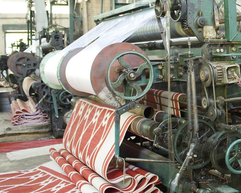 Rolls of fabric coming off a loom