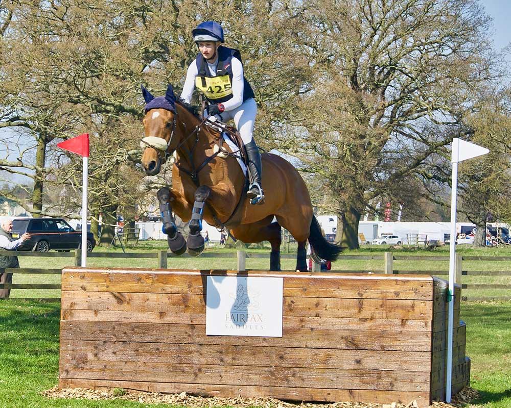 Horse and rider going over a jump